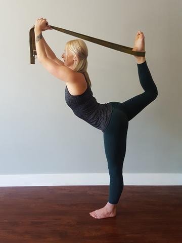 Girl-stretching-her-legs-with-yoga-straps